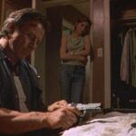 City of Industry 1997 Movie Scene Harvey Keitel as Roy Egan cleaning his gun while Famke Janssen as Rachel is watching him
