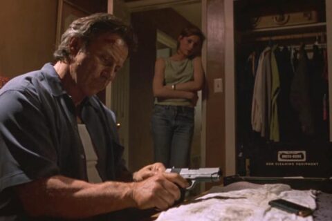 City of Industry 1997 Movie Scene Harvey Keitel as Roy Egan cleaning his gun while Famke Janssen as Rachel is watching him