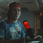 Dumb Money 2023 Movie Scene Paul Dano as Keith Gill AKA Roaring Kitty during his podcasts about the GameStop stock options and short squeeze