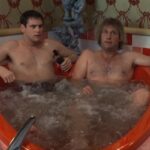 Dumb and Dumber 1994 Movie Scene Jeff Daniels as Harry and Jim Carrey as Lloyd in a heart shaped tub in a motel