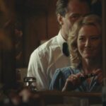 The Nest 2020 Movie Scene Carrie Coon as Allison putting makeup on while Jude Law as Rory is seducing her
