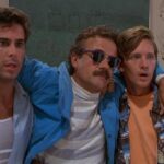 Weekend at Bernie's 1989 Movie Scene Andrew McCarthy as Larry and Jonathan Silverman as Richard holding the dead body of Terry Kiser as Bernie Lomax, their boss, and pretending he's alive