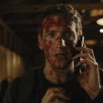 You Might Be The Killer 2018 Movie Scene Fran Kranz as Sam covered in blood talking over the phone