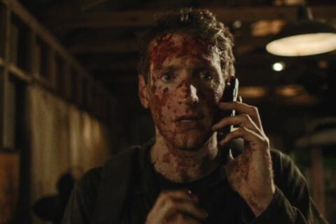 You Might Be The Killer 2018 Movie Scene Fran Kranz as Sam covered in blood talking over the phone