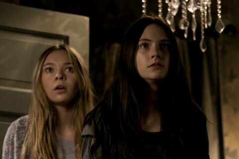 Incident in a Ghostland 2018 Movie Scene Emilia Jones as Young Beth and Taylor Hickson as Young Vera seeing intruders break into their house