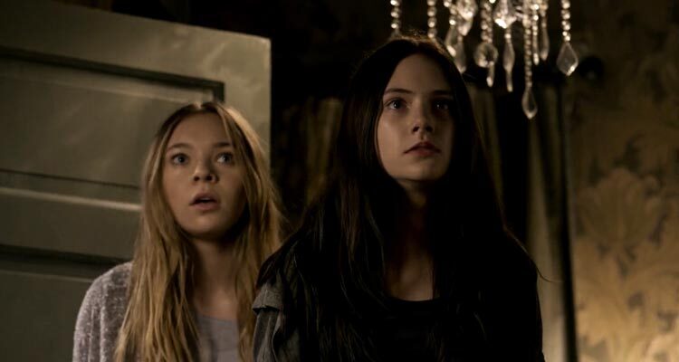 Incident in a Ghostland 2018 Movie Scene Emilia Jones as Young Beth and Taylor Hickson as Young Vera seeing intruders break into their house