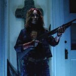 Night of the Demons 2009 Movie Scene Monica Keena as Maddie all bloody holding a shotgun