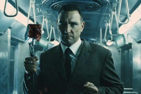 The Midnight Meat Train 2008 Movie Scene Vinnie Jones as Mahogany holding a bloody butchers hammer in the train