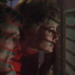 Cape Fear 1991 Movie Scene Nick Nolte as Sam Bowden and Jessica Lange as Leigh watching through the shutters of their window at Max Cady