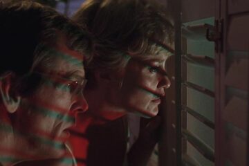 Cape Fear 1991 Movie Scene Nick Nolte as Sam Bowden and Jessica Lange as Leigh watching through the shutters of their window at Max Cady