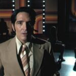 Late Night With The Devil 2023 Movie Scene David Dastmalchian as Jack Delroy announcing his guests, a demonically possessed girl and her doctor